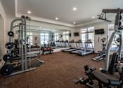 Thumbnail 17 of 26 - A spacious home gym with a variety of exercise equipment. at Hall Creek Apartment Homes, Tennessee