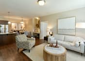 Thumbnail 6 of 26 - A well-lit living room with a white sofa and a wooden coffee table. at Hall Creek Apartment Homes, Tennessee