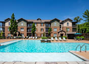 Thumbnail 1 of 26 - A large apartment complex with a swimming pool in front. at Hall Creek Apartment Homes, Tennessee, 38002
