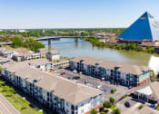 Thumbnail 23 of 25 - an aerial view of apartment buildings with the pyramids in the background at Grand Island Apartments in Memphis TN 38103