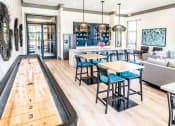 Thumbnail 21 of 25 - Clubhouse with Shuffleboard Table at Grand Island Apartments, Memphis, TN