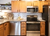 Thumbnail 1 of 25 - Kitchen with Stainless Steel Appliances at Grand Island Apartments, Memphis