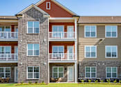 Thumbnail 27 of 28 - A multi-story apartment building with balconies and windows. at Grays Creek Apartments, Cordova, TN, 38018