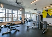 Thumbnail 21 of 28 - A gym with a variety of equipment including treadmills, weights, and exercise machines. at Grays Creek Apartments, Cordova