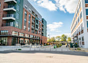 Thumbnail 37 of 37 - A modern building with a parking lot at Harbor Side at Conwood Flats Apartments in Uptown Memphis, TN