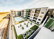 Thumbnail 12 of 37 - A modern apartment complex with a pool and landscaped courtyard at Harbor Side at Conwood Flats Apartments, Memphis