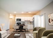 Thumbnail 3 of 37 - A modern living room with a dining area and kitchen in the background at Harbor Side at Conwood Flats Apartments in Uptown Memphis, TN