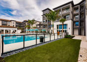 Thumbnail 15 of 18 - Side yard at the pool at Harrison Apartments, Florida, 34243