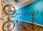 Thumbnail 13 of 14 - A room with a blue wall and a bicycle hanging on the wall at Highland Row Apartments, Tennessee, 38111