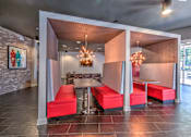 Thumbnail 11 of 14 - A room with a table and chairs with a red cushion at Highland Row Apartments, Memphis