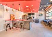 Thumbnail 10 of 14 - A bar area with a counter and stools at Highland Row Apartments, Memphis, Tennessee