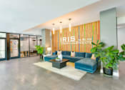 Thumbnail 36 of 38 - A modern living room with a blue couch and a sign that says "IRIS LUXURY APARTMENT".