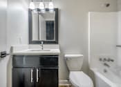 Thumbnail 16 of 38 - A bathroom with a sink, toilet, and bathtub.at Iris Luxury Apartments, Tennessee  