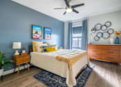 Thumbnail 11 of 38 - A bedroom with a bed, nightstand, and a ceiling fan.at Iris Luxury Apartments, Tennessee, 38105