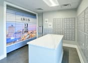 Thumbnail 37 of 38 - A white reception desk in front of a wall of mailboxes and a window showing a cityscape.
