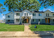 Thumbnail 1 of 28 - A two-story house with a front yard and a tree at Kiwi Goji Apartments, TN, 38111