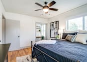 Thumbnail 20 of 28 - a view of a bed in a bedroom with blue comforter and white blanket at Kiwi Goji Apartments, Tennessee, 38111