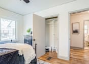 Thumbnail 21 of 28 - A bedroom with a bed, dresser, and mirror at Kiwi Goji Apartments, Memphis, Tennessee