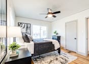 Thumbnail 19 of 28 - a bedroom with a ceiling fan at Kiwi Goji Apartments, Memphis, TN,  38111