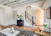 Thumbnail 9 of 28 - Living Room of a home with a staircase at Kiwi Goji Apartments, Memphis, Tennessee