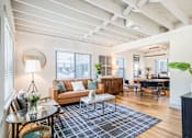 Thumbnail 6 of 28 - a living room with mid century modern brown and blue accents at Kiwi Goji Apartments, Tennessee