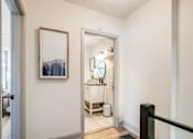 Thumbnail 25 of 28 - A bathroom with a white vanity and a mirror at Kiwi Goji Apartments, Memphis, TN,  38111