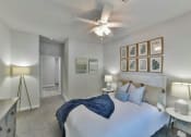 Thumbnail 7 of 28 - a bedroom with a bed and a ceiling fan