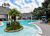 Thumbnail 11 of 27 - A pool with a small island in the middle of it.