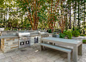 Thumbnail 18 of 29 - A stone barbecue area with a bench and a grill. at Manchester at Mansell, Roswell 