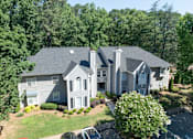 Thumbnail 28 of 29 - A large house with a grey roof and a white garage door. at Manchester at Mansell, Roswell Georgia 