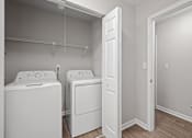 Thumbnail 6 of 29 - A laundry room with a washer and dryer. at Manchester at Mansell, Georgia 