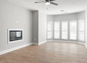 Thumbnail 5 of 29 - A spacious room with a fireplace and a ceiling fan. at Manchester at Mansell, Roswell, GA 30076 