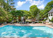 Thumbnail 17 of 29 - A large swimming pool surrounded by trees and a white house. at Manchester at Mansell, Roswell 
