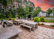 Thumbnail 24 of 29 - A backyard with a picnic table and benches. at Manchester at Mansell, Roswell, 30076 