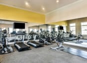 Thumbnail 18 of 29 - a large fitness room with cardio equipment and flat screen televisions at Meridian Park in Collierville, TN 38017