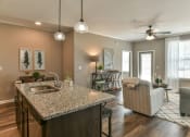 Thumbnail 4 of 29 - a kitchen with an island and a living room in the background at Meridian Park in Collierville, TN 38017