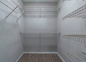 Thumbnail 9 of 27 - Empty white pantry with shelves and a carpeted floor. at Mill House at East Cobb, Marietta, 30067 