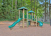 Thumbnail 25 of 27 - A playground with a green slide and a wooden structure. at Mill House at East Cobb, Marietta, 30067 