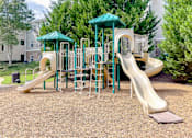 Thumbnail 28 of 30 - A playground with a green roof and a yellow slide.