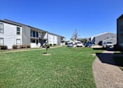Thumbnail 23 of 24 - Lush green lawn area at Normandy Woods in Riviera East, Houston, TX, 77015
