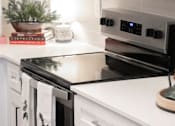 Thumbnail 4 of 21 - Kitchen with stove top oven at The One at Millington, Millington, TN, 38053
