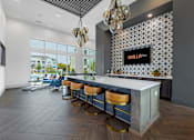 Thumbnail 8 of 25 - A bar area with a white counter and blue stools.