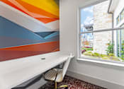 Thumbnail 22 of 25 - A room with a white desk and a chair.