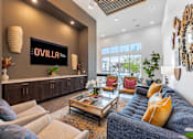 Thumbnail 11 of 25 - A living room with a large couch and a coffee table.