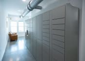 Thumbnail 16 of 21 - a room with a bunch of lockers and a chair at Lakeland Town Square Apartments, Lakeland