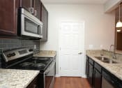 Thumbnail 2 of 31 - Granite Counter Tops In Kitchen at Park Summit Apartments, Decatur, 30033