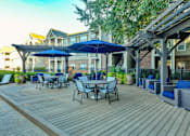 Thumbnail 15 of 31 - Sundeck with Tables, Chairs, and Cushioned Seating at Polos at Hudson Corners Apartments, South Carolina 29650