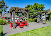 Thumbnail 13 of 22 - Patio with Red Chairs at The Addison at Collierville Apartments, Tennessee, 38017