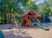 Thumbnail 20 of 36 - a swing set with a jungle gym in the middle of a park  at Grove Point, Georgia
