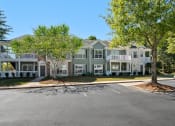 Thumbnail 32 of 33 - Exterior with Lush Landscaping and large patios located at St. Andrews Apartments in Johns Creek, GA 30022